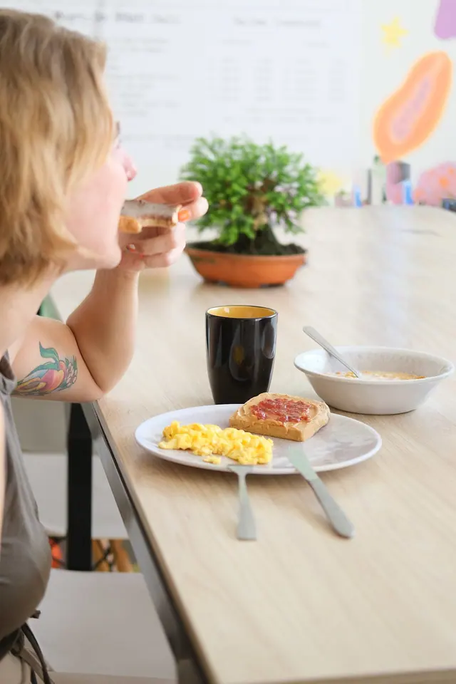 Breakfast in the dining room: scrambled eggs, toast with jam and a coffee.