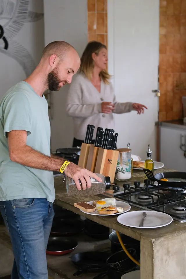 Guests cooking breakfast together in the communal kitchen.